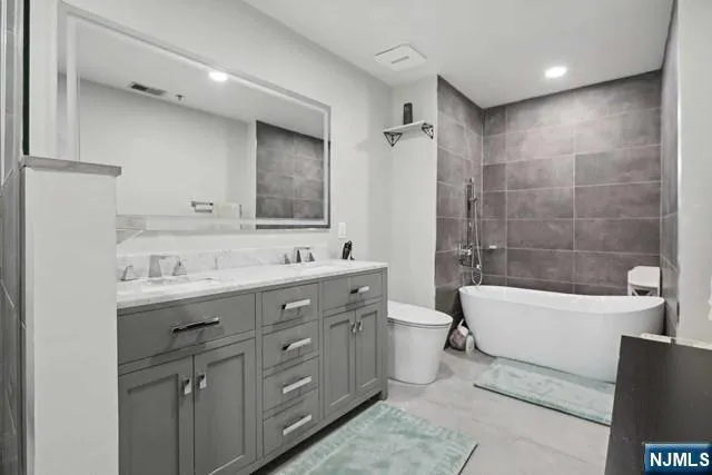 a bedroom with a bed and a couch