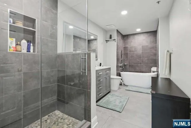 a white toilet sitting next to a bathroom sink