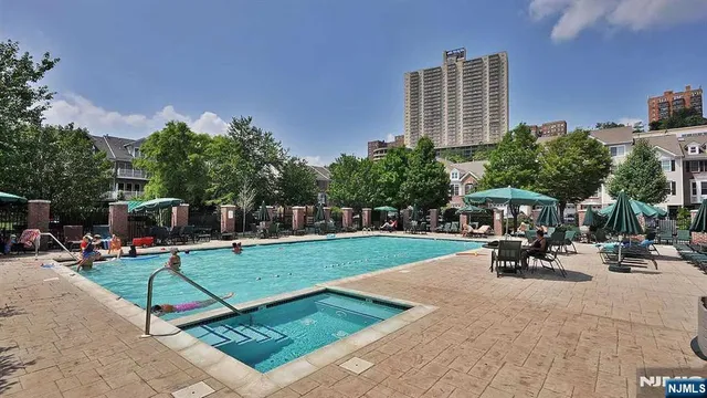 a view of a yard with plants and a bench