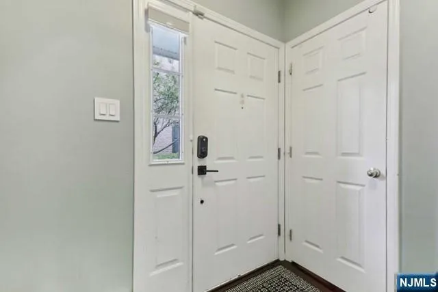 a view of staircase with wooden floor and white walls