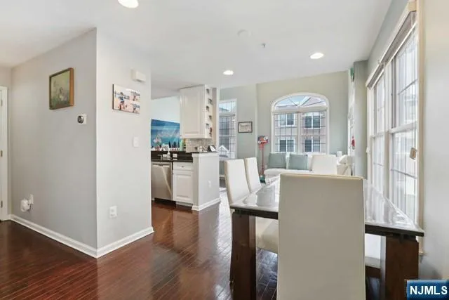 a view of a kitchen with cabinets and wooden floor