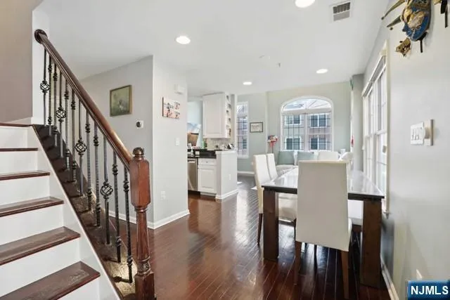 a dining room with furniture and wooden floor