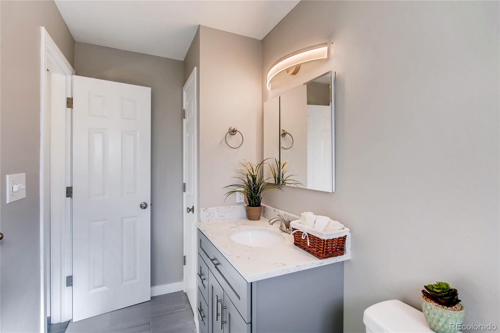 1404 Sinton Road Evergreen, CO 80439 - Photo 16 of 29 a bathroom with a sink and mirror with toilet