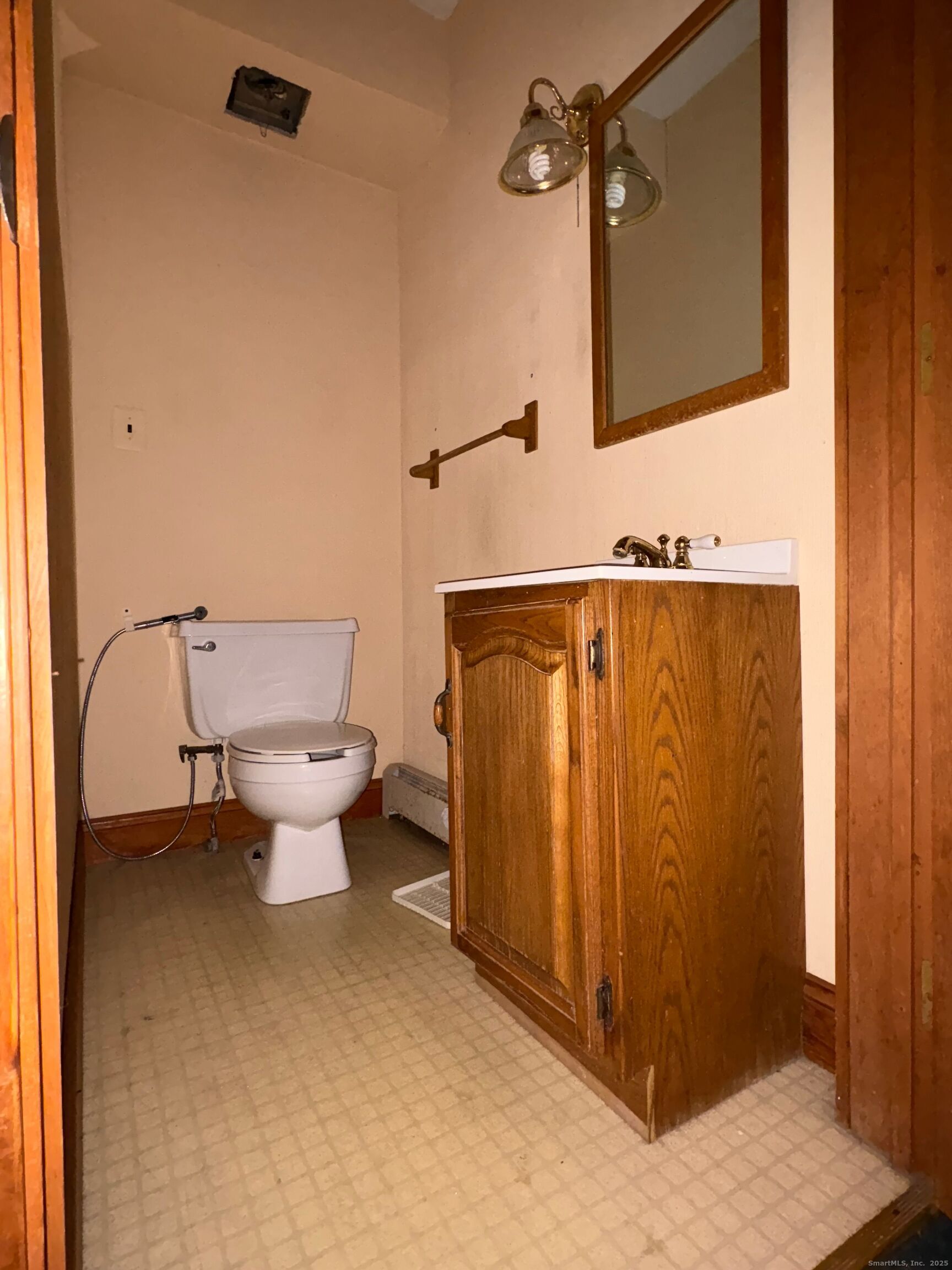 173 Leesville Road Moodus, CT 06469 - Photo 2 of 17 a bathroom with a toilet a sink and mirror