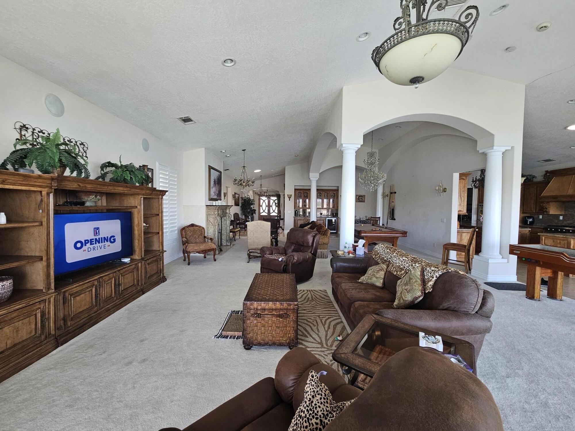 26461 Edgewater Lane Helendale, CA 92342 - Photo 18 of 24 a living room with furniture a fireplace and a flat screen tv