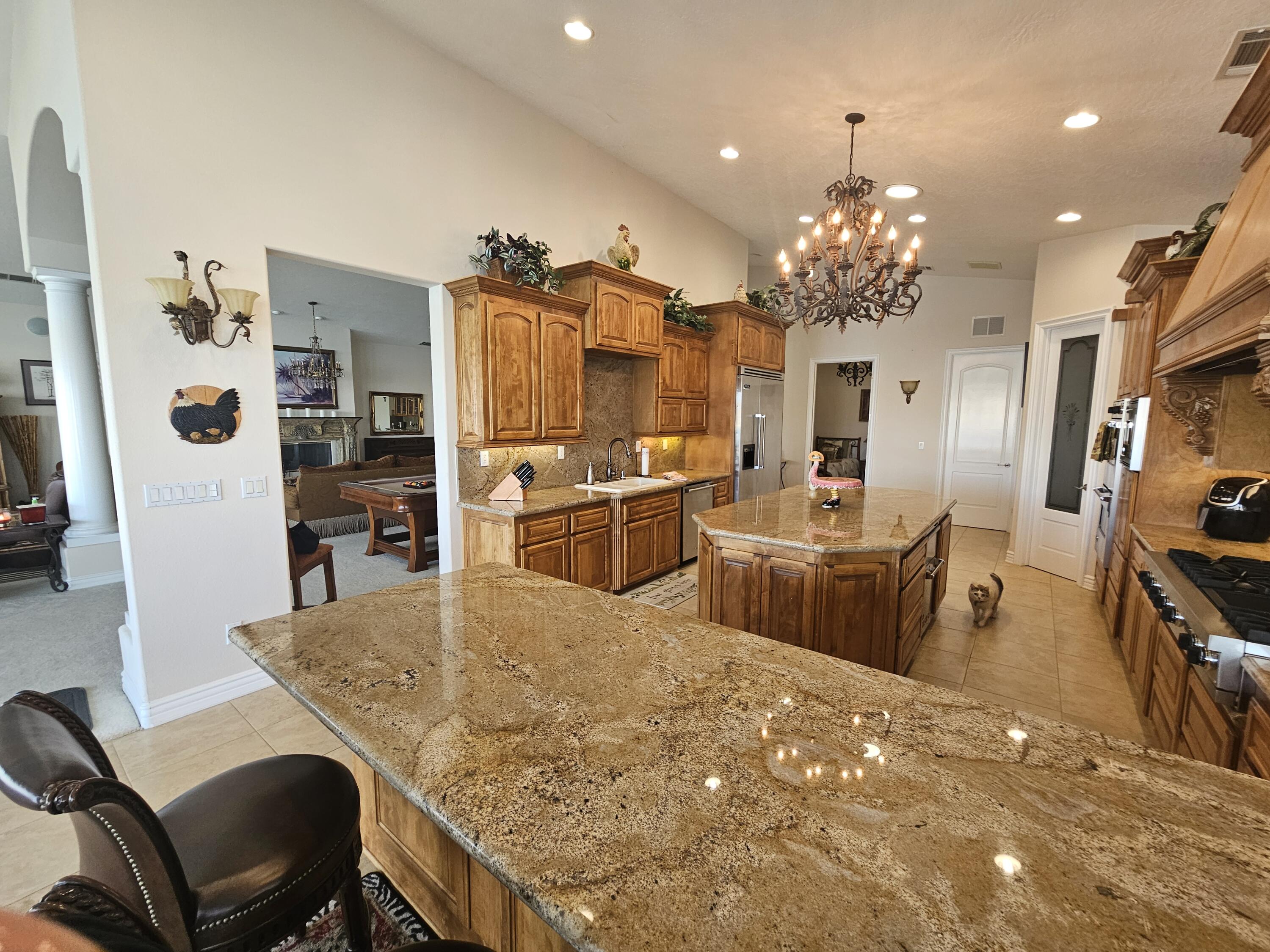 26461 Edgewater Lane Helendale, CA 92342 - Photo 3 of 24 a view of a dining room with furniture and chandelier