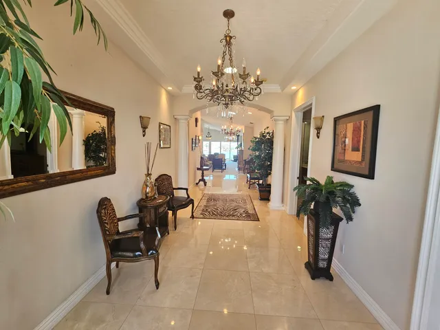 a lobby with furniture and a chandelier