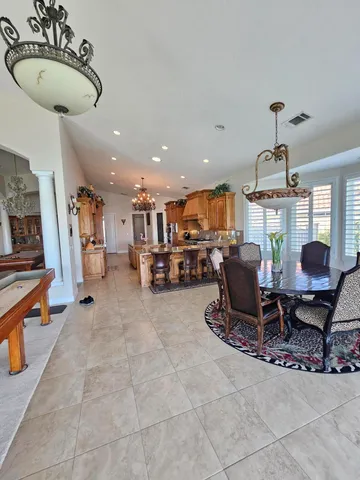 a living room with furniture a dining table and kitchen view
