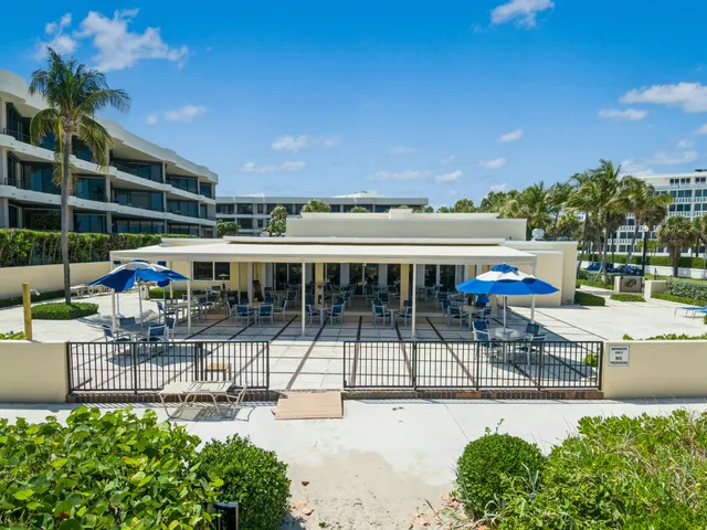 an aerial view of residential houses with outdoor space and lake view