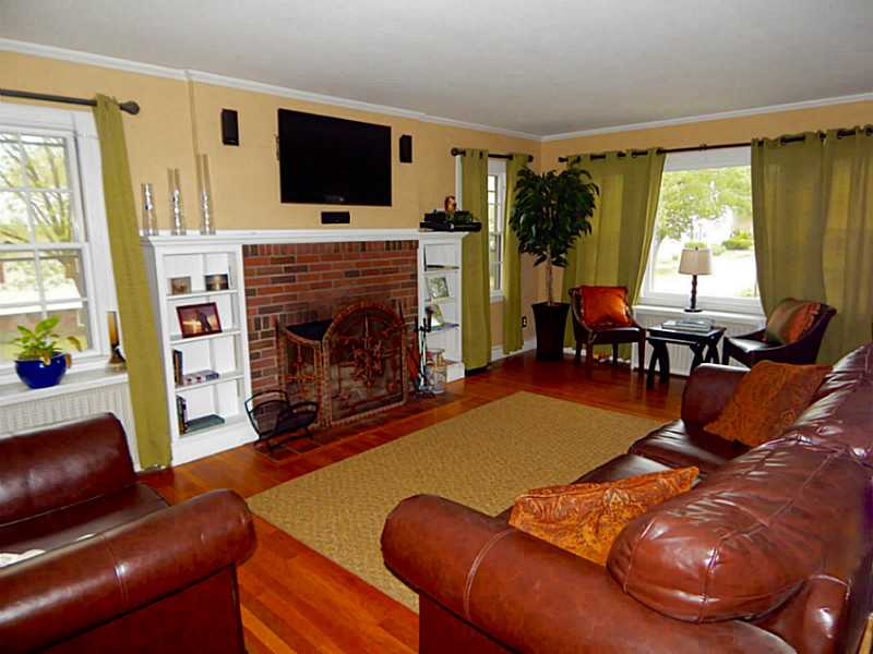 Living Room. Living room with brick fireplace and buit-in shelves