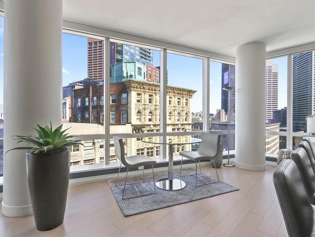 a living room with furniture and large windows