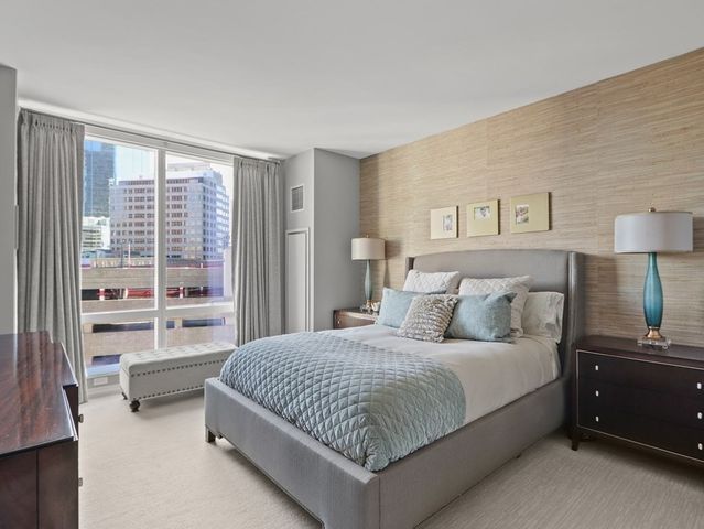 a bedroom with a bed and a night stand