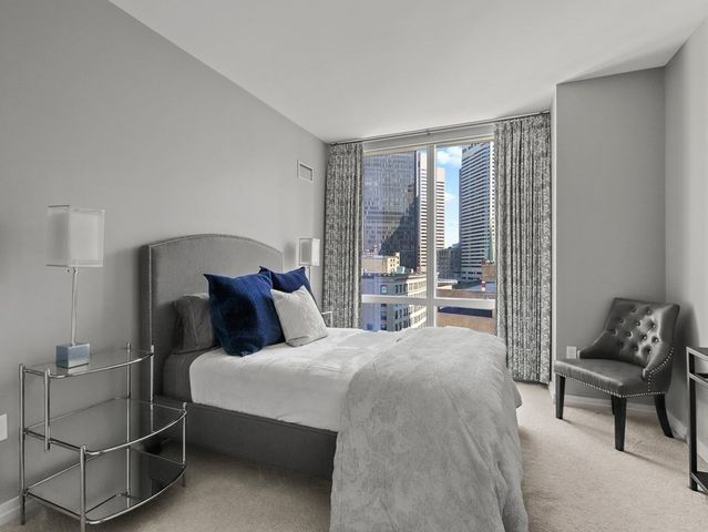 a bedroom with a bed and glass window