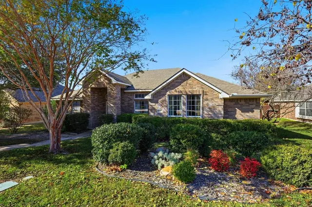 a view of a house with a yard and plants