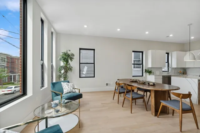 a living room with furniture a window and a table