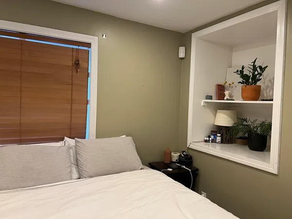 a bedroom with a bed and a chandelier