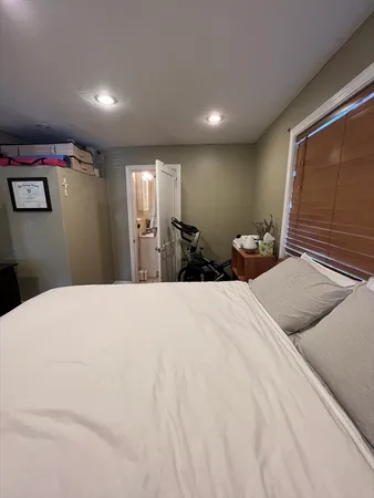 a bedroom with a bed and a large mirror