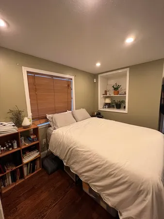 a bedroom with a bed and a book shelf