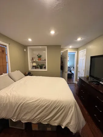 a bedroom with a bed and a flat screen tv