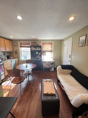 a bedroom with furniture and a wooden floor