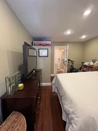 a bedroom with a bed and a flat screen tv