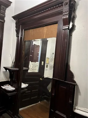 a view of closet with a mirror
