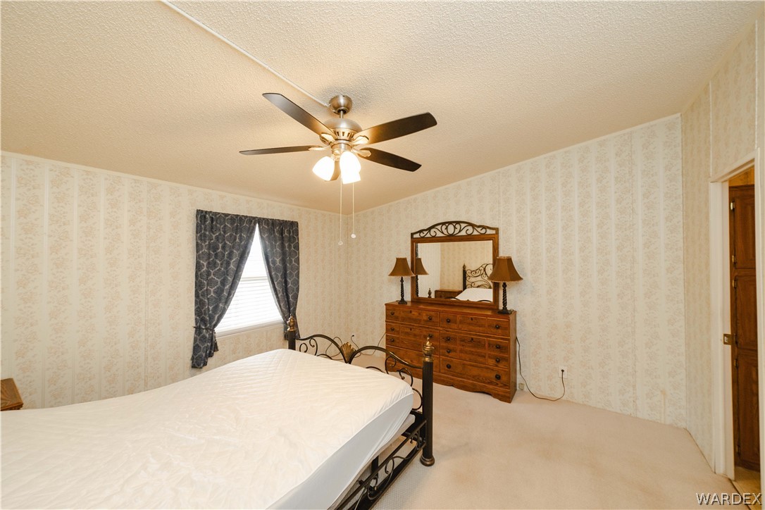 3003 Hualapai Mountain Road Kingman, AZ 86401 - Photo 16 of 49 a bedroom with a bed and a dresser