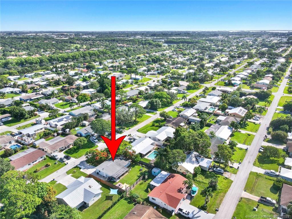 1790 Southeast Madison Street Stuart, FL 34997 - Photo 1 of 24 an aerial view of residential houses with outdoor space and swimming pool