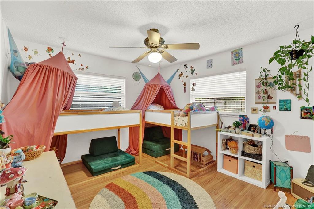 1790 Southeast Madison Street Stuart, FL 34997 - Photo 16 of 24 a bedroom with furniture and a fireplace