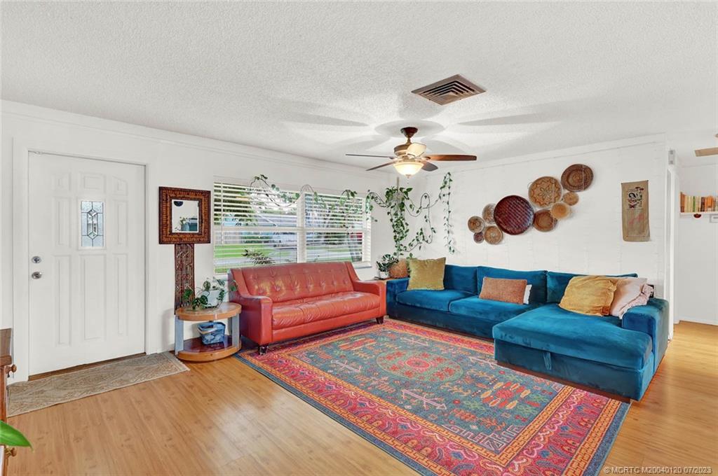 1790 Southeast Madison Street Stuart, FL 34997 - Photo 2 of 24 a living room with furniture and wooden floor
