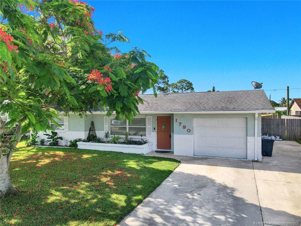 1790 Southeast Madison Street Stuart, FL 34997 - Photo 24 of 24 a house view with a sitting space and garden