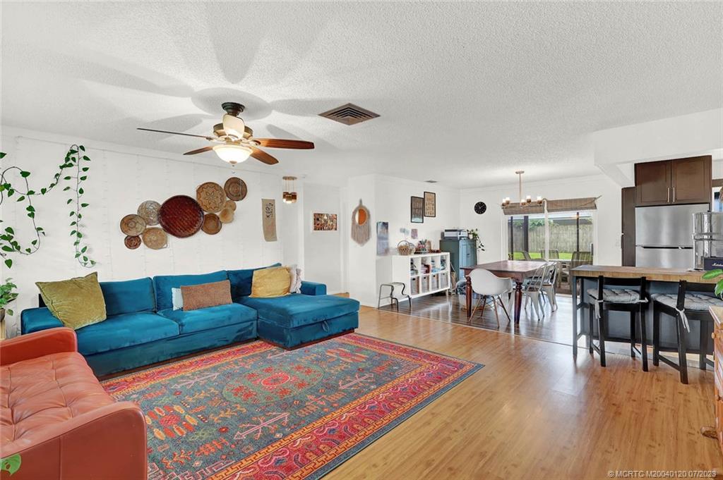 1790 Southeast Madison Street Stuart, FL 34997 - Photo 3 of 24 a living room with furniture and wooden floor