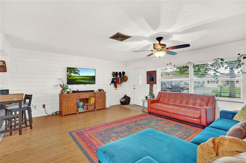 1790 Southeast Madison Street Stuart, FL 34997 - Photo 4 of 24 a living room with furniture and a flat screen tv