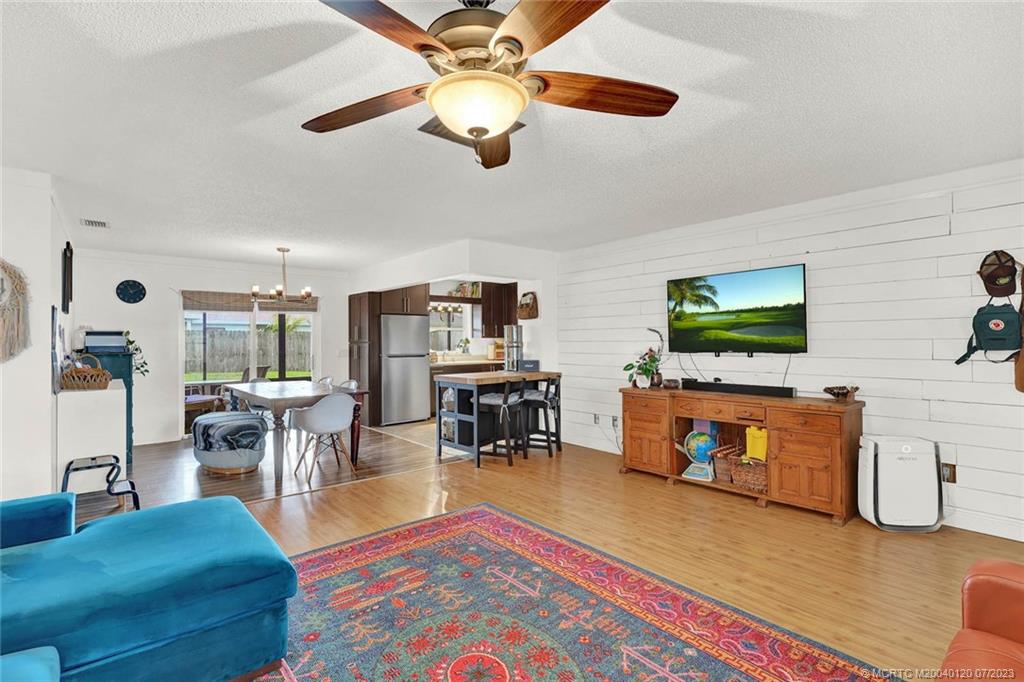 1790 Southeast Madison Street Stuart, FL 34997 - Photo 5 of 24 a living room with furniture and a flat screen tv