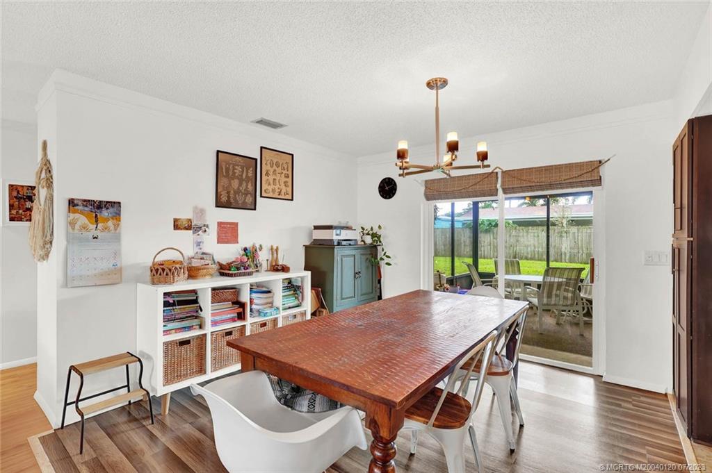 1790 Southeast Madison Street Stuart, FL 34997 - Photo 7 of 24 a view of a dining room with furniture window and wooden floor