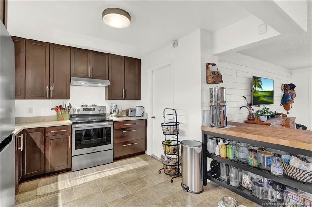 1790 Southeast Madison Street Stuart, FL 34997 - Photo 10 of 24 a kitchen with stainless steel appliances granite countertop a stove and a sink