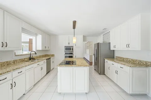 a kitchen with a sink stove and refrigerator