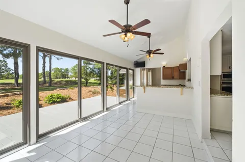a view of a livingroom with a ceiling fan a ceiling fan and window