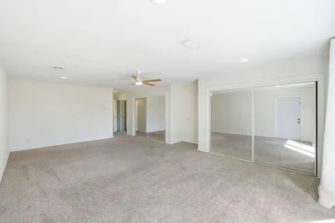 an empty room with windows and entrance