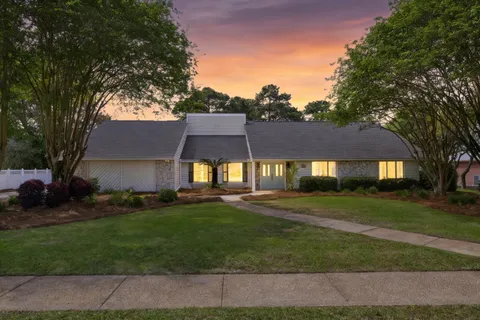 a view of house with a yard
