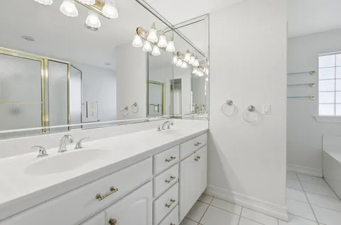 a bathroom with a double vanity sink mirror and toilet