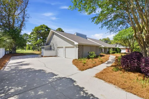 a view of a house with backyard and a tree