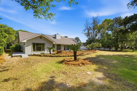 a front view of a house with a big yard