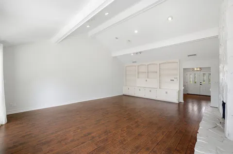 an empty room with wooden floor