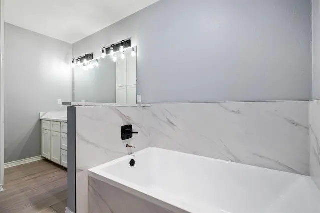 a bathroom with a bathtub and shower