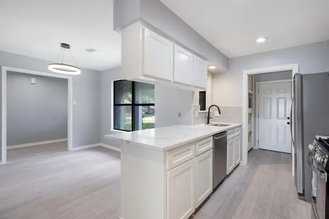 a kitchen with a sink stove and refrigerator