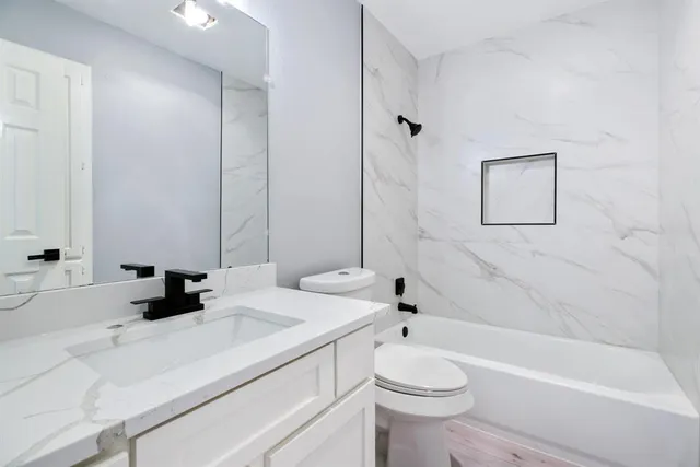 a bathroom with a sink a toilet and a bathtub