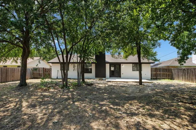 front view of a house with a tree