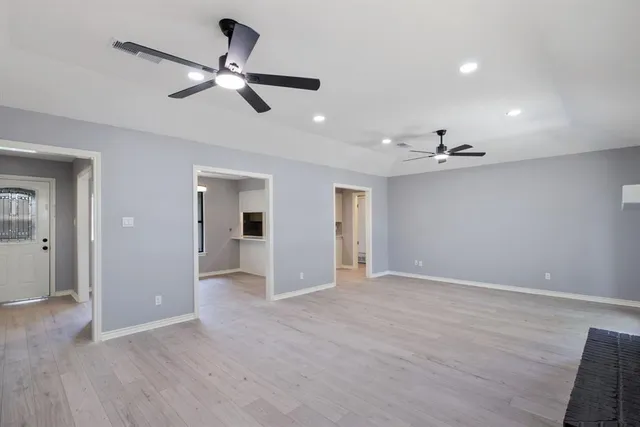 a view of an empty room and wooden floor