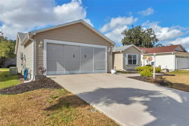 a view of a house with a yard and garage